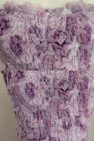 Strapless fitted mini dress with 3D floral ruffles and ruched bodice.